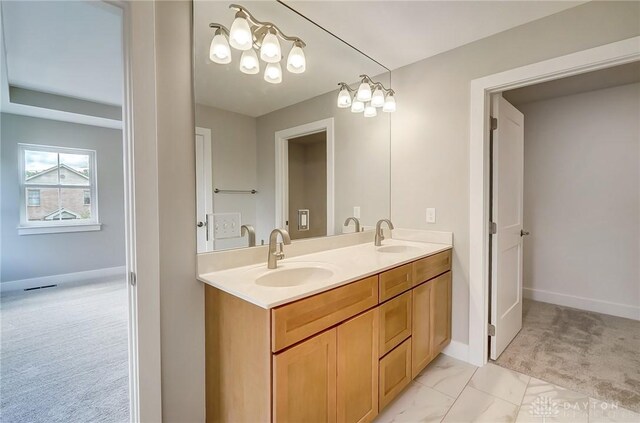 bathroom featuring vanity and a notable chandelier