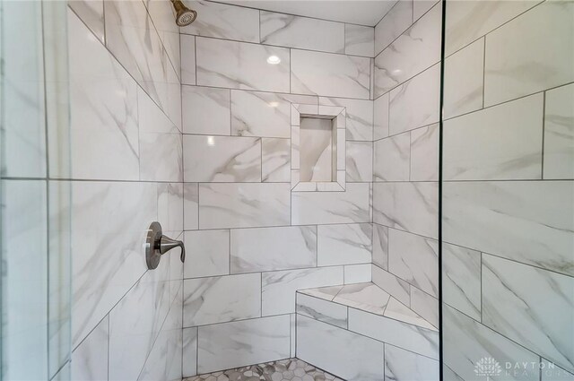 bathroom with tiled shower