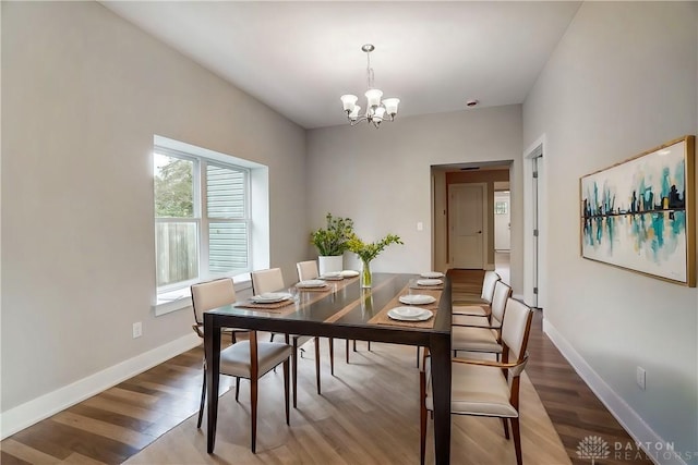 dining area with a notable chandelier and wood-type flooring