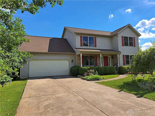 view of front of property with a front yard and a garage