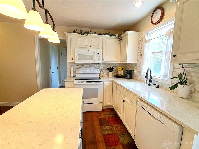 kitchen with decorative backsplash, white appliances, dark hardwood / wood-style flooring, decorative light fixtures, and sink