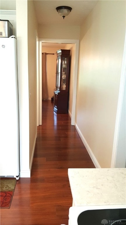 corridor with dark hardwood / wood-style floors