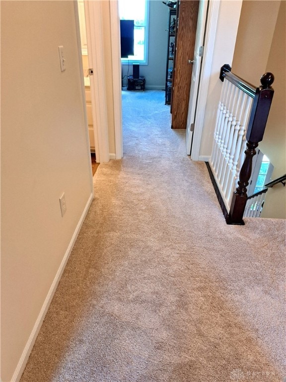 hallway with light carpet