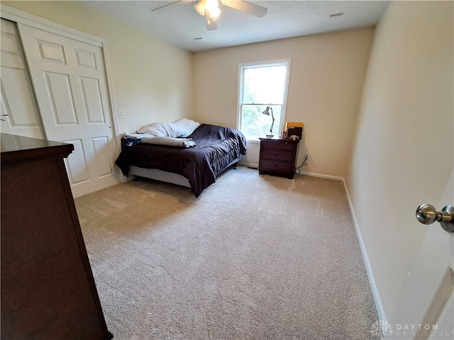 bedroom featuring light carpet and ceiling fan