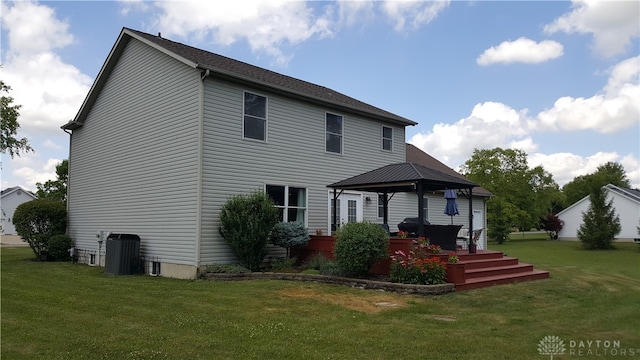 rear view of house with a lawn, a deck, central AC, and a gazebo