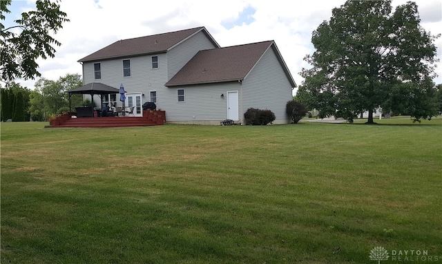 back of house featuring a lawn, a wooden deck, and a gazebo