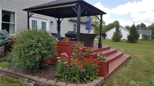 deck featuring area for grilling, a gazebo, and a yard