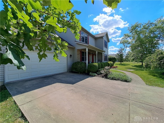 view of front of home featuring a garage and a front yard