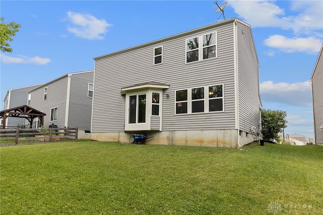 rear view of property with a yard