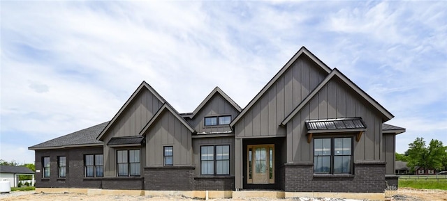 4870 Bunnell Hill Rd, Lebanon, OH 45036 - view of front facade featuring board and batten siding, a standing seam roof, brick siding, and metal roof