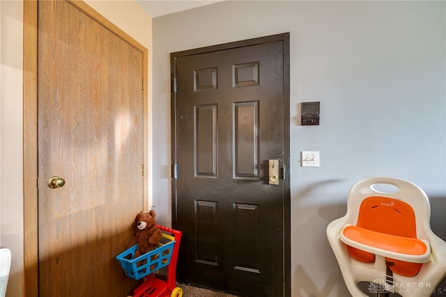 foyer with a textured ceiling