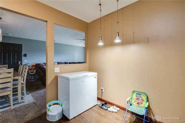 clothes washing area featuring dark hardwood / wood-style floors and a textured ceiling