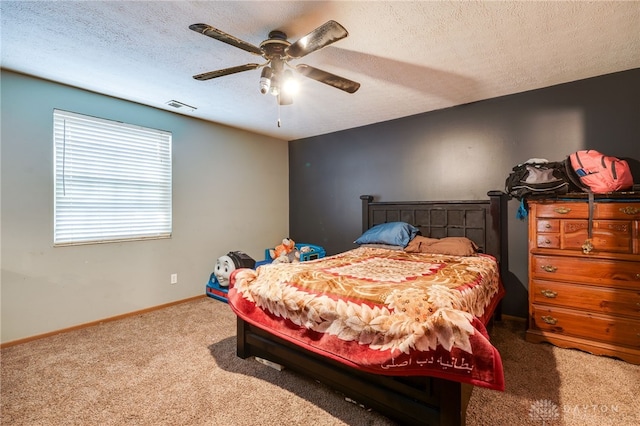 bedroom featuring ceiling fan, carpet, and a textured ceiling