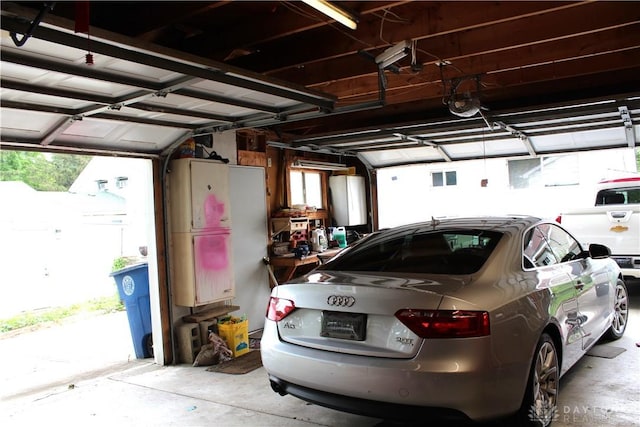 garage featuring a garage door opener and a carport