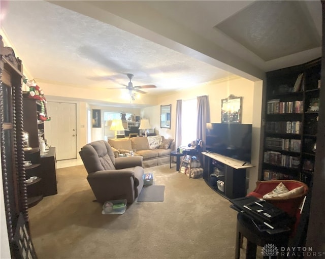 carpeted living room featuring a textured ceiling and ceiling fan