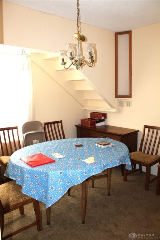 carpeted dining area featuring an inviting chandelier