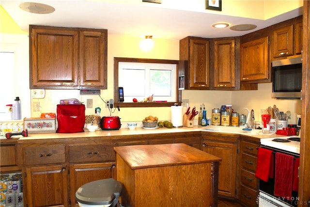 kitchen featuring butcher block counters, sink, and electric stove