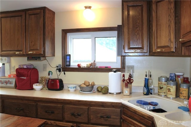 kitchen featuring dark brown cabinetry and sink