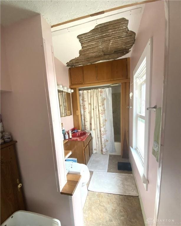 bathroom featuring vanity and shower / bath combination with curtain