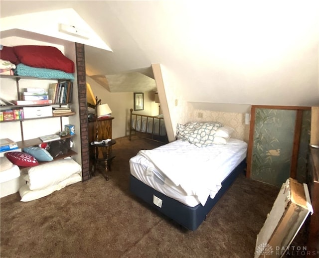 carpeted bedroom with brick wall and lofted ceiling