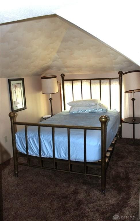 carpeted bedroom with lofted ceiling