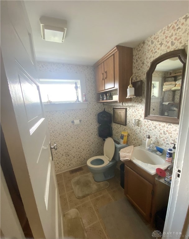 bathroom with vanity, toilet, and tile patterned floors