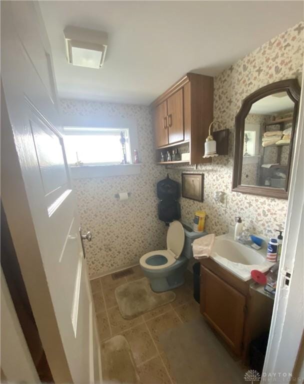 bathroom with vanity and toilet