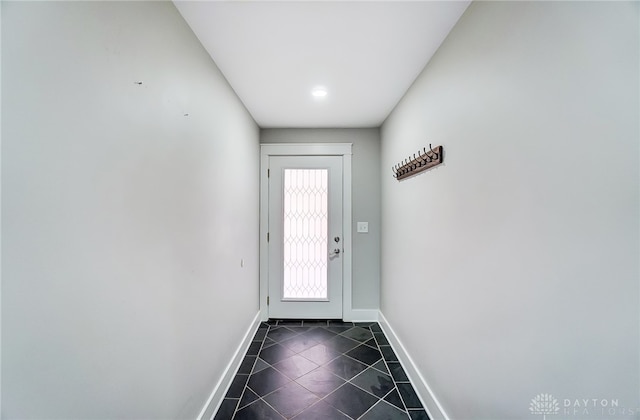 doorway featuring dark tile patterned floors