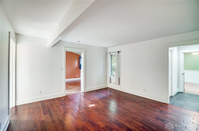 empty room with dark hardwood / wood-style flooring