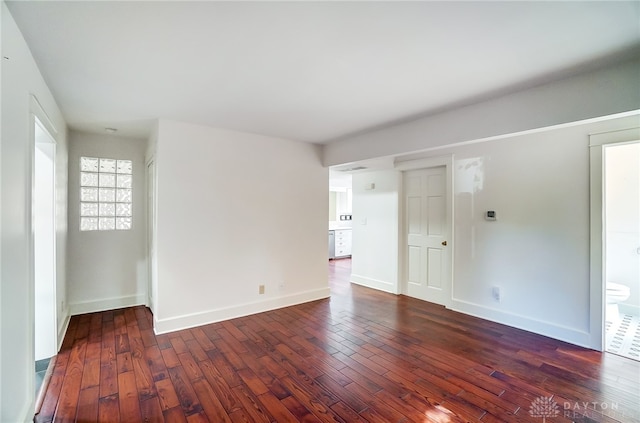 spare room featuring dark hardwood / wood-style flooring