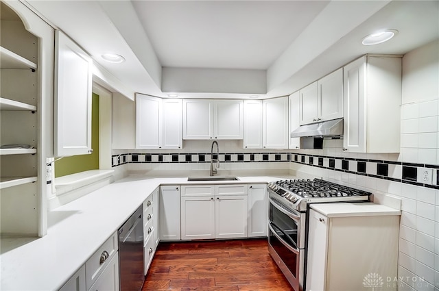 kitchen featuring white cabinetry, sink, stainless steel appliances, dark hardwood / wood-style floors, and decorative backsplash