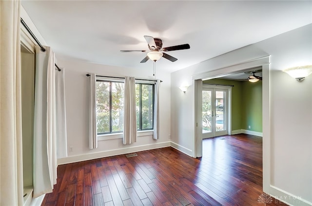 unfurnished room with plenty of natural light, dark wood-type flooring, and french doors