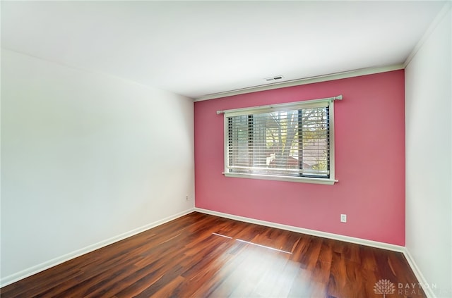 unfurnished room featuring dark hardwood / wood-style floors and crown molding