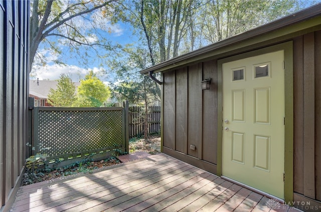 wooden terrace with a storage shed