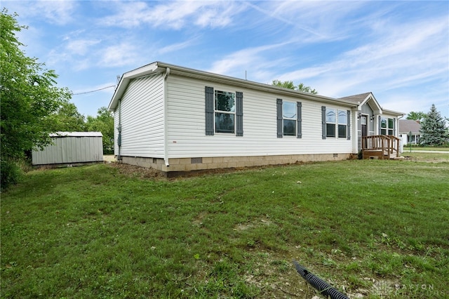 view of home's exterior with a storage shed and a lawn