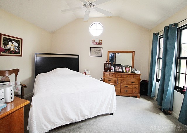 bedroom featuring vaulted ceiling, carpet floors, and ceiling fan