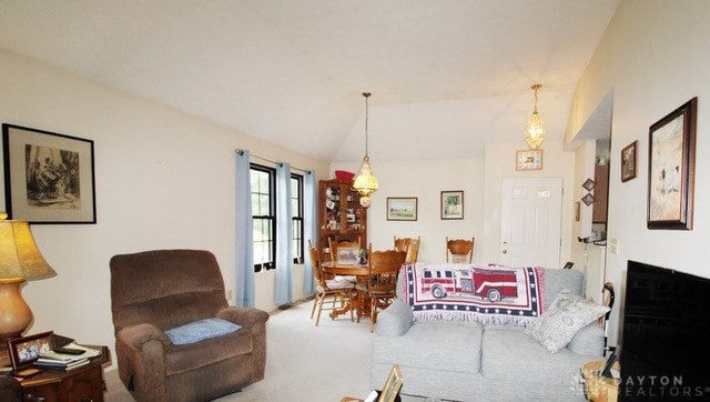 carpeted living room with vaulted ceiling