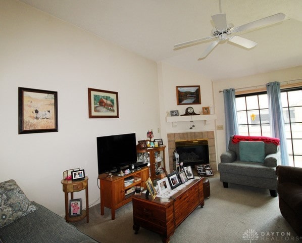 living room featuring a fireplace, carpet flooring, and ceiling fan