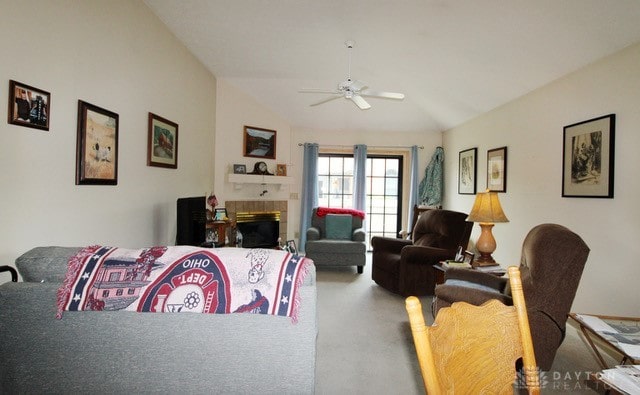 carpeted living room featuring vaulted ceiling and ceiling fan