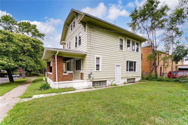 back of property with a yard and a porch