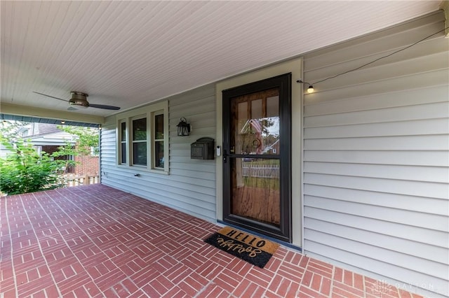 property entrance featuring covered porch and ceiling fan