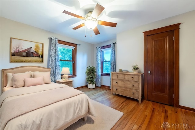 bedroom with ceiling fan and light hardwood / wood-style flooring