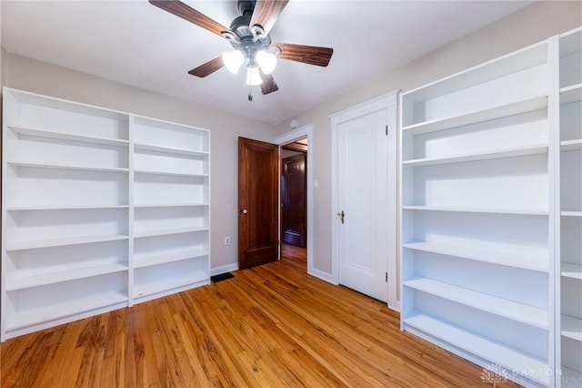 unfurnished bedroom with ceiling fan and light hardwood / wood-style floors