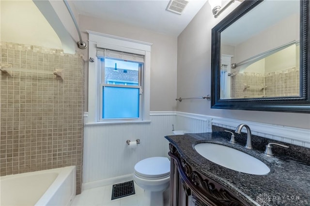 full bathroom featuring toilet, tiled shower / bath combo, tile patterned flooring, and vanity