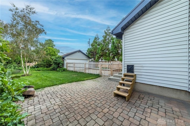 view of patio / terrace featuring an outbuilding and a garage