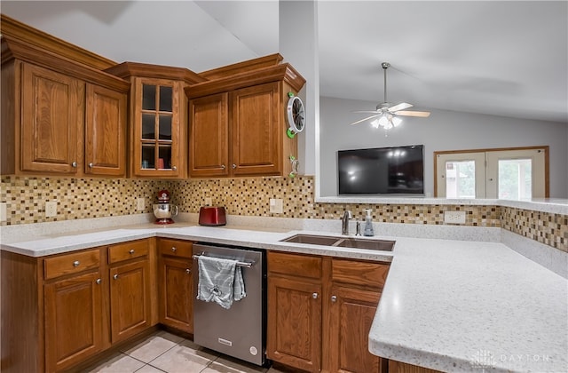 kitchen with sink, ceiling fan, decorative backsplash, vaulted ceiling, and stainless steel dishwasher