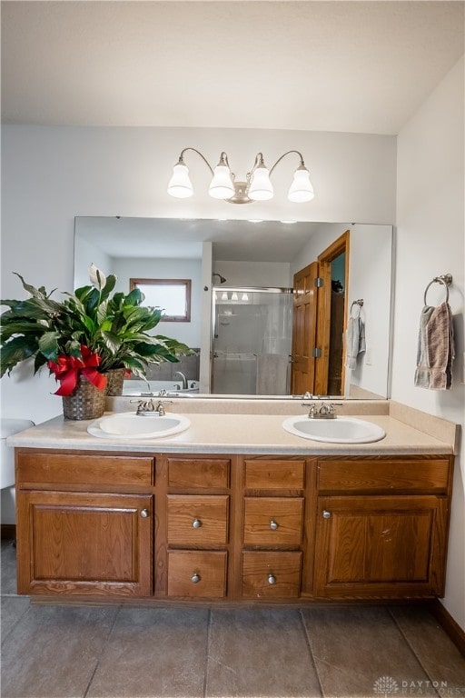 bathroom with vanity, a shower with shower door, and tile patterned flooring