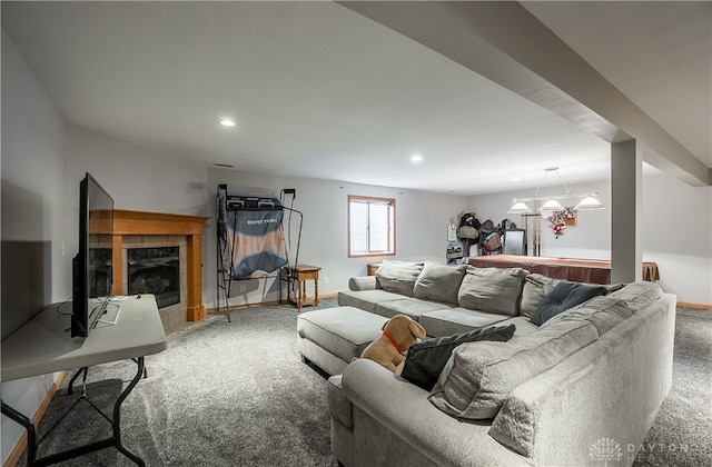 living room featuring a fireplace, carpet, and a notable chandelier