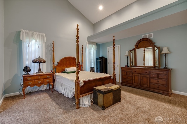 bedroom featuring light carpet and high vaulted ceiling