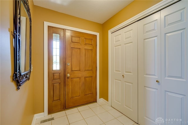 tiled foyer with a textured ceiling